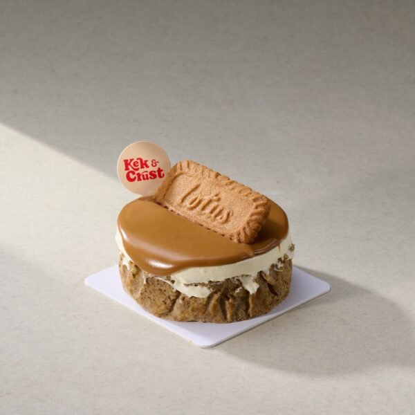 Earl Grey Lemon Burnt Cheesecake topped with biscoff glaze and cookie by Kek & Crust