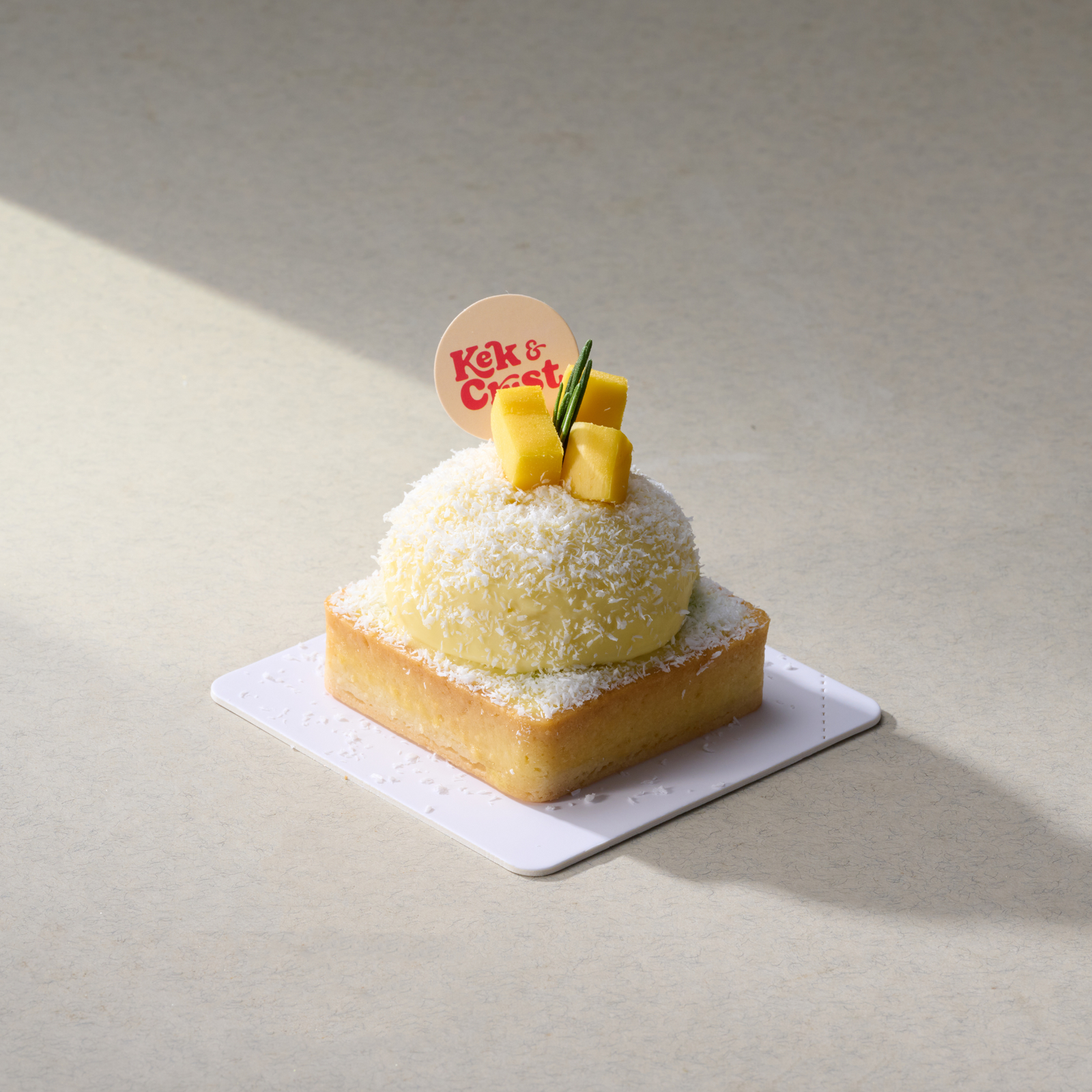 mango coconut cream tart with mango cubes and shredded coconut on top