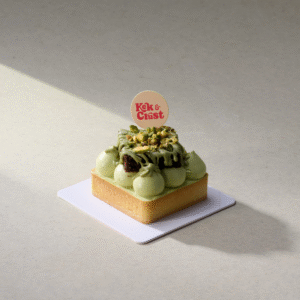 Pistachio Brownie Tart with brownie chunks, pistachio paste filling, and pistachio cream topping