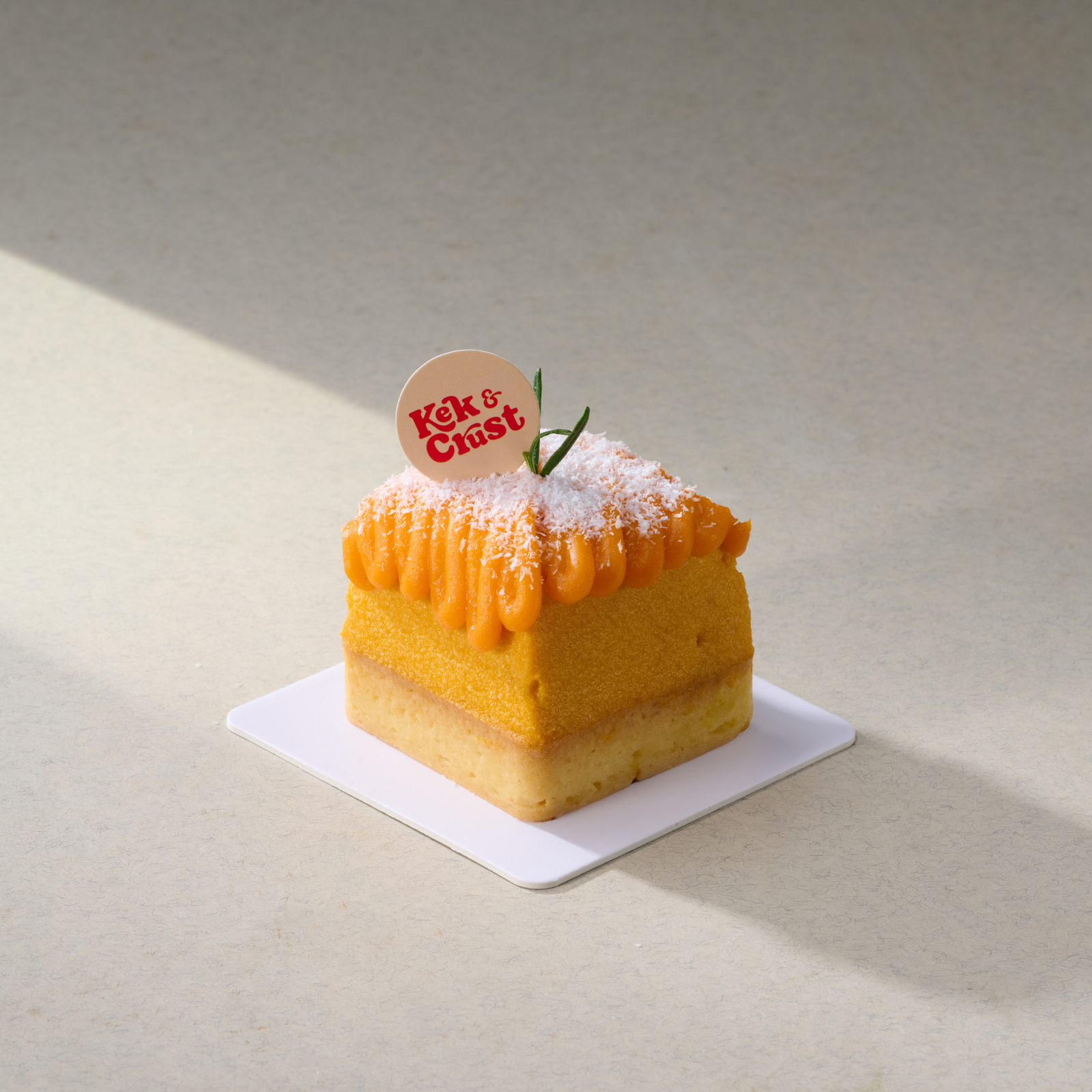 pumpkin salted egg tart with coconut flakes on top
